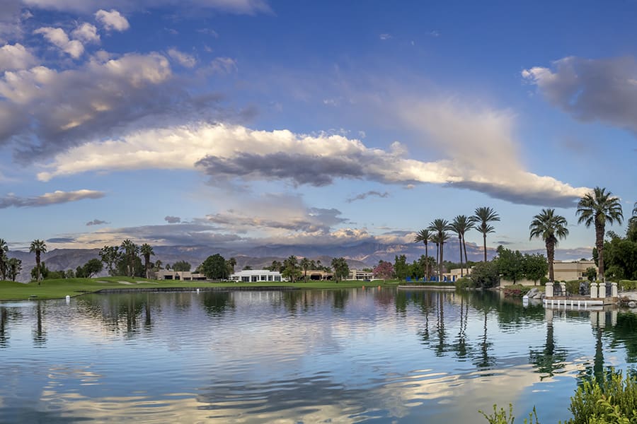 Contact - Portrait View of Golf Course in California with Palm Trees and Water on a Summer Day at Dusk