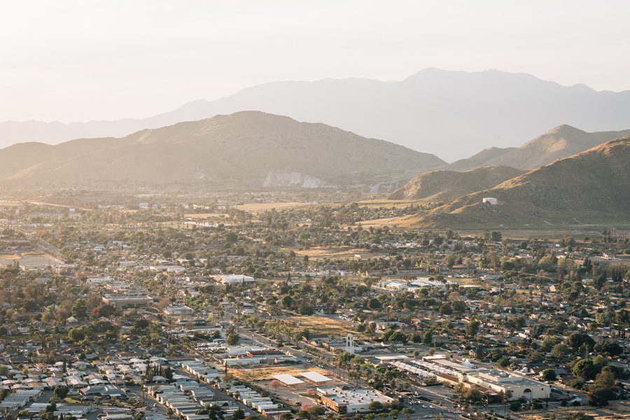 Riverside, CA - Aerial View of a Riverside County City in California at Sunset With Community and Mountains in the Background