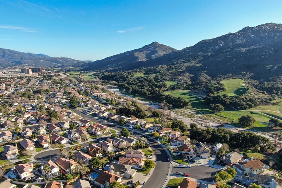 Temecula, CA - Aerial View of Residential Neighborhood with Mountains Overlooking Homes in Background